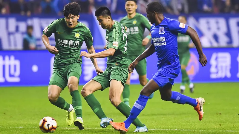 Cầu thủ Shanghai Shenhua và Beijing Guoan tranh chấp bóng